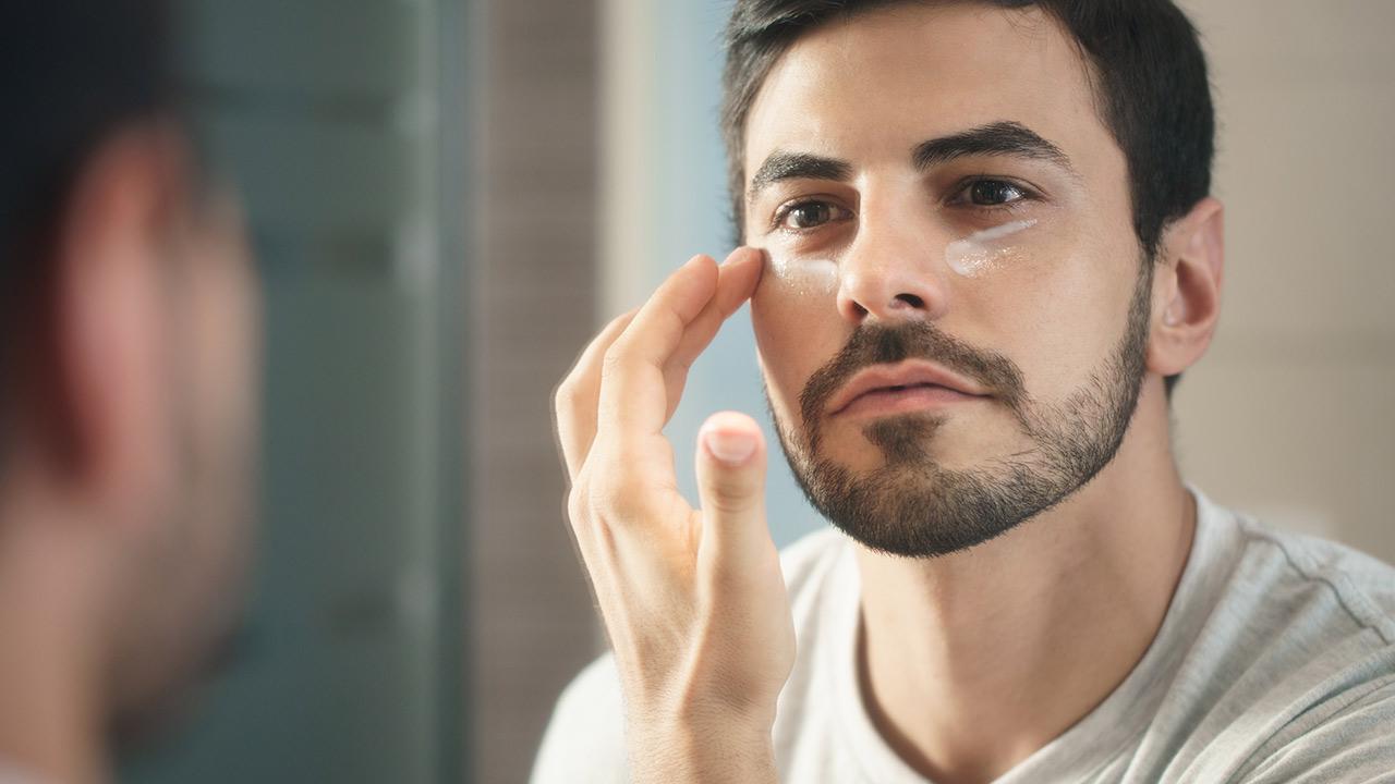 Welche Pflegecreme braucht der moderne Mann - Mann trägt Augencreme auf